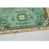 2 Francs currency with written note