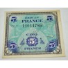 Monnaie de 5 francs avec note écrite