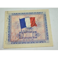 Monnaie de 5 francs avec note écrite