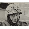 Photo of GI with makeshift winter camouflage on helmet