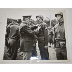 Photo of GI's wearing camouflaged liners at ceremony
