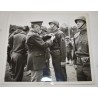 Photo of GI's wearing camouflaged liners at ceremony