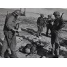 Photo of 7th Division GI's with wounded prisoner at Kwajalein