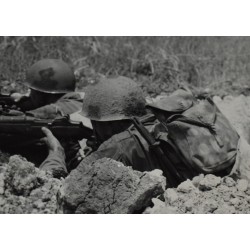 Photo of GI's with camouflaged helmets