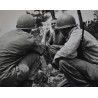 Photo of Medics giving plasma to casualty