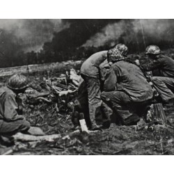 Photo of 7th Division GI's firing 75mm Howitzer