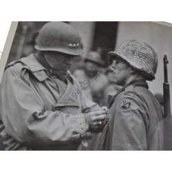 Photo of General Patton decorating a 94th Division GI